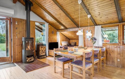 a living room with a table and a wood stove at 3 Bedroom Beautiful Home In Hundested in Hundested