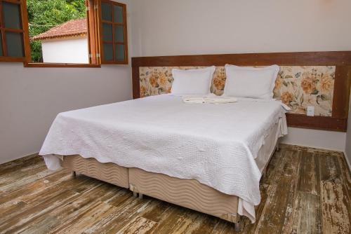 Ένα ή περισσότερα κρεβάτια σε δωμάτιο στο Pousada São Manoel