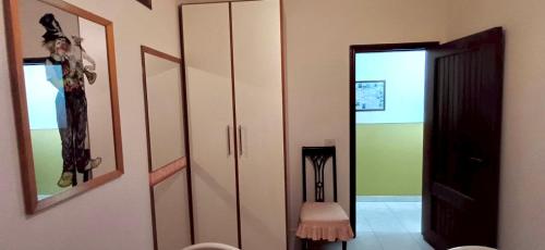 a room with a closet and a door with a mirror at Apartments Mikros in Giardini Naxos