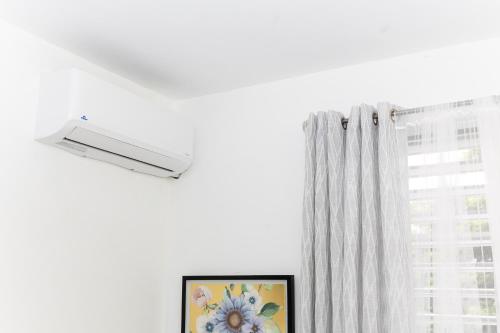 a window with a white curtain and a picture at Casa Marino - RELAX just minutes from Beaches in Llanos Tuna