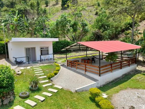 a small house with a red roof at Casa campestre Los Nogales BC in Manaure Balcón del Cesar