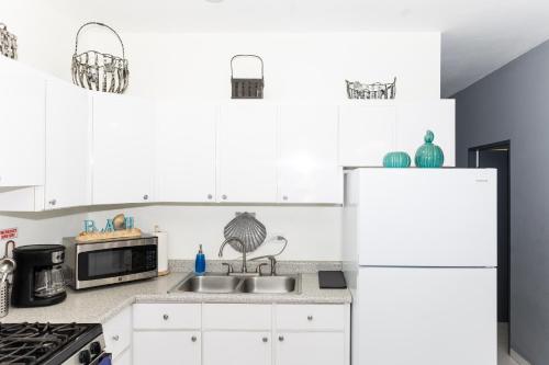 a kitchen with white cabinets and a white refrigerator at Casa Marino - RELAX just minutes from Beaches in Llanos Tuna