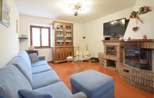 a living room with a couch and a tv at 3 Bedroom Gorgeous Home In Camaiore in Camaiore