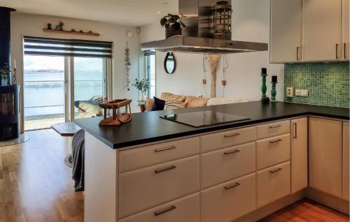 a kitchen with a sink and a counter top at Beach Front Home In Rönnäng With Sauna in Rönnäng