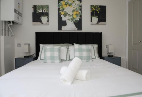 a bedroom with a white bed with flowers on it at Stadium View, by Cardiff Central, Free Parking in Cardiff