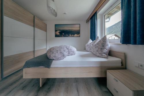 a bed in a room with a window at Apartment Linde in Lermoos