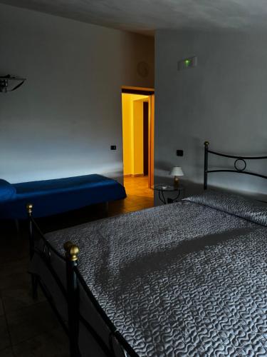 a bedroom with a bed and a blue couch at Agriturismo Quota 700 in Sicignano degli Alburni
