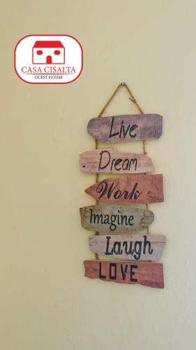 a sign that reads live dream work imagine laugh love at Casa Cisalta N4 - Quarto Compartilhado in Praia