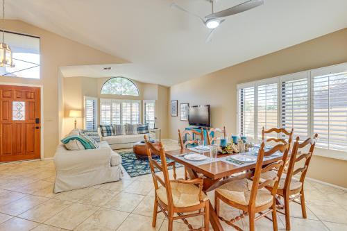 a dining room and living room with a table and chairs at Half-Mi to Dtwn Lakefront Gilbert Home! in Gilbert