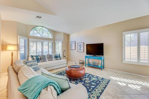 a living room with a couch and a tv at Half-Mi to Dtwn Lakefront Gilbert Home! in Gilbert