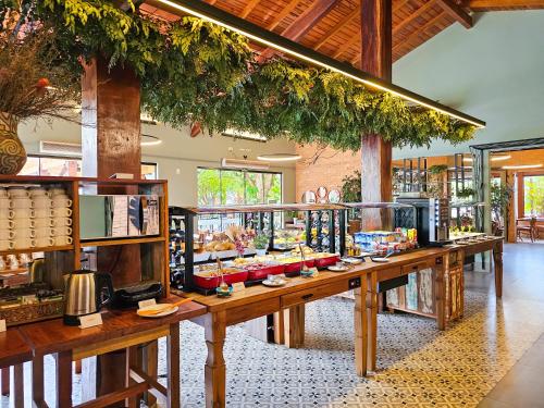 a long table with food on it in a restaurant at Arte da Natureza Hotel Bonito in Bonito