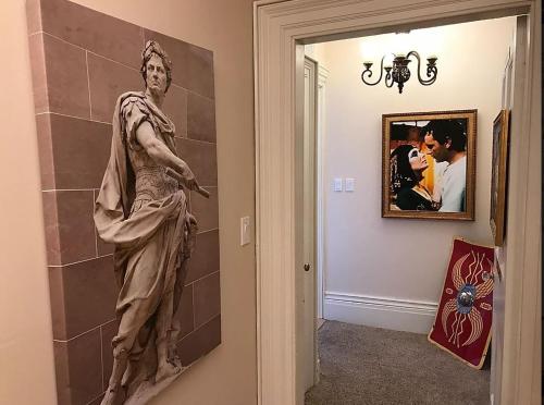 a statue of a man on a wall in a hallway at Noble Waterfront Suites in Brockville