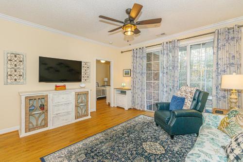 a living room with a couch and a flat screen tv at Cozy 2BR at Barefoot! Perfect for 4! Unit 414 in North Myrtle Beach