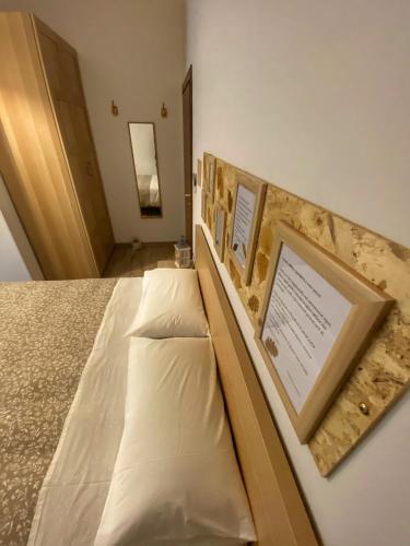a bedroom with a bed with a picture on it at Il Giardino Segreto in Assisi