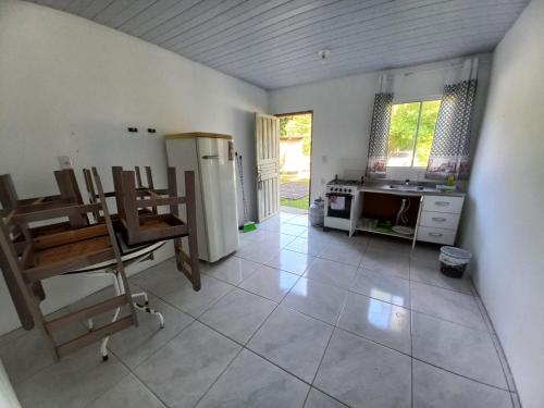 a kitchen with a refrigerator and a table at Guesthouse da Barra in Florianópolis