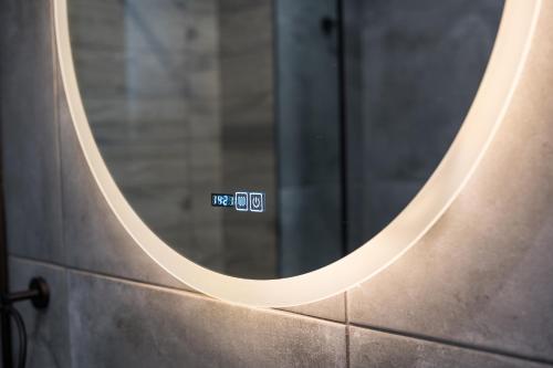 a mirror on a wall with a sign on it at AEOLIS SUITES in Athens