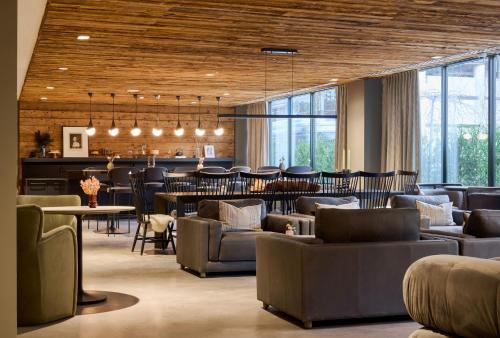 a lobby with couches and tables and a bar at Luxury Apartments by Hyatus at The Asher in Stamford