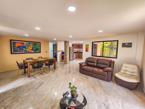 a living room with a couch and a table at Finca,lago de pesca,piscina natural,moderna in Rionegro