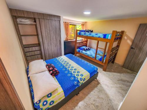 a small bedroom with a bunk bed and a bunk bed at Finca,lago de pesca,piscina natural,moderna in Rionegro