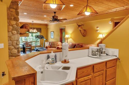 a kitchen with a sink and a living room at Spacious Chalet Hot Tub Sauna Holiday Valley in Ellicottville