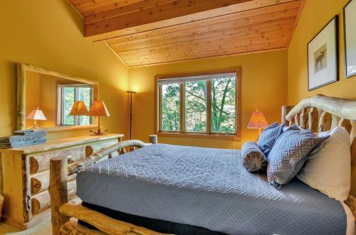 a bedroom with a bed and a wooden ceiling at Spacious Chalet Hot Tub Sauna Holiday Valley in Ellicottville