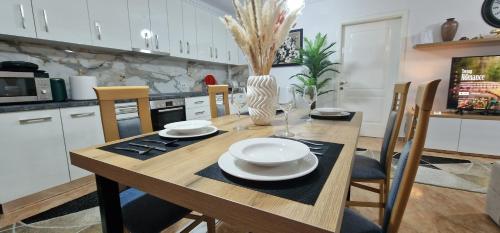 a kitchen with a wooden table with chairs and a dining room at Daily rent apartment city center Elbasan 6 in Elbasan