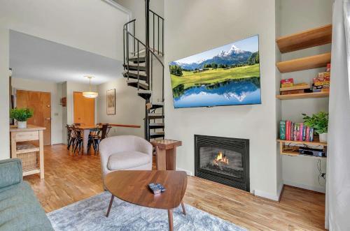a living room with a fireplace and a table at Updated Ski In Ski Out Condo Holiday Valley in Ellicottville