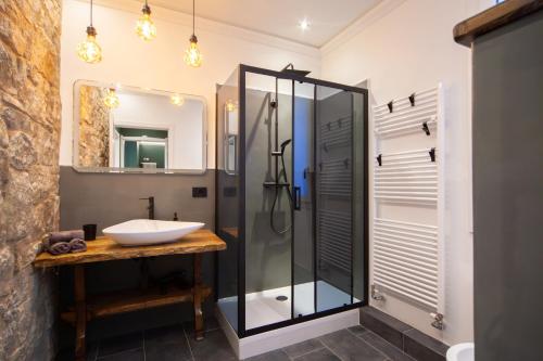a bathroom with a glass shower and a sink at MENTORE MAISON PRESTiGE in Noceto