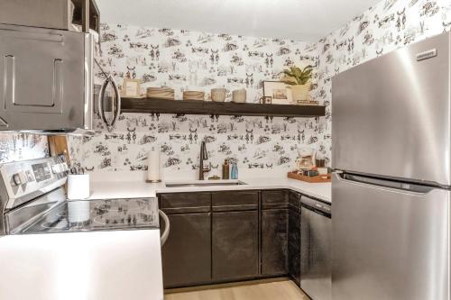 a kitchen with a stainless steel refrigerator and floral wallpaper at Ski In Ski Out 3-bed 2-bath Condo King Bed in Ellicottville