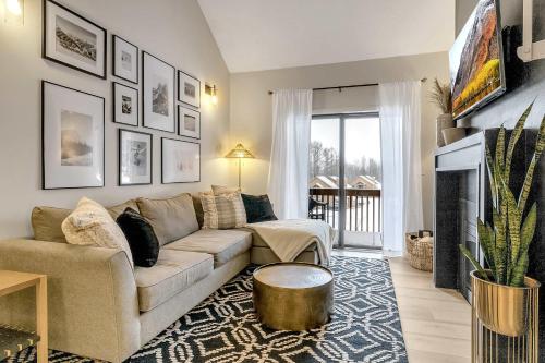 a living room with a couch and a fireplace at Ski In Ski Out 3-bed 2-bath Condo King Bed in Ellicottville