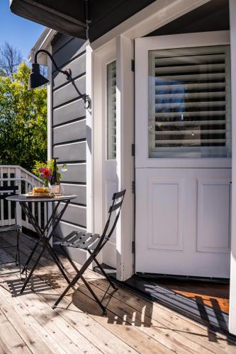 a porch with a table and a white door at Brannan Cottage Inn in Calistoga