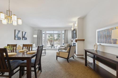 a dining room and living room with a table and chairs at Blue Mountain Retreat at Rivergrass in Blue Mountains