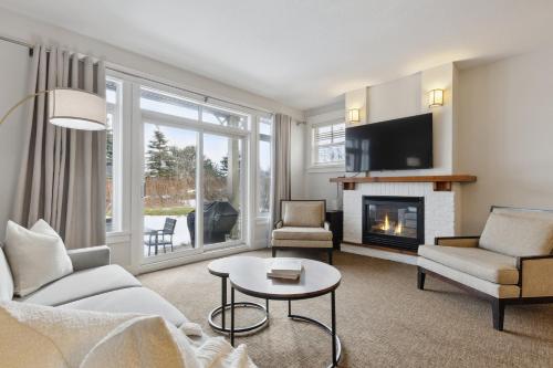 a living room with a couch and a fireplace at Blue Mountain Retreat at Rivergrass in Blue Mountains