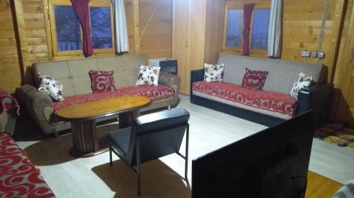 a living room with a couch and a table at Villa Alpina in Boge
