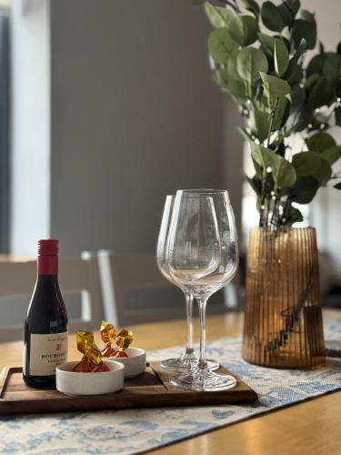 a bottle of wine and a wine glass on a table at Dublin Private Room in Dublin