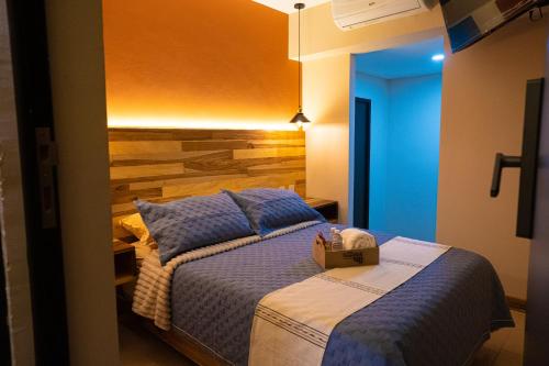 a bedroom with a bed with a box on it at Hotel Casa Tsumbak in Tuxtla Gutiérrez