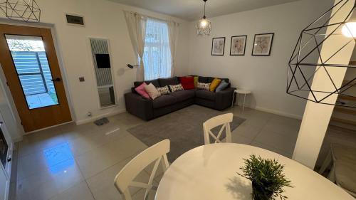 a living room with a table and a couch at BALI House Bucharest in Bucharest