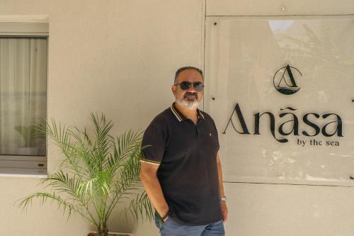 a man standing in front of a building at Αnasa by the sea in Agia Pelagia