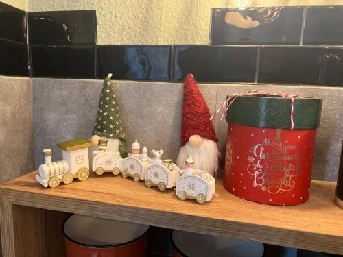 a shelf with a toy train and a santa hat at Petit cocon proche de Stanislas in Nancy