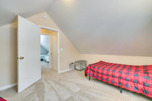 a bedroom with a bed and an open door at 2 Blocks to Higgins Lake Family-Friendly Home in Roscommon