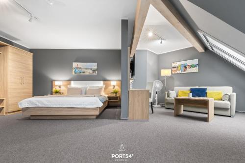 une chambre avec un lit king size et un canapé dans l'établissement Ferienwohnung Bude 4 Dagebüll, à Dagebüll