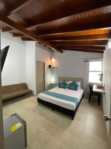 a bedroom with a large bed and a desk at Hotel 12 Nights in Medellín