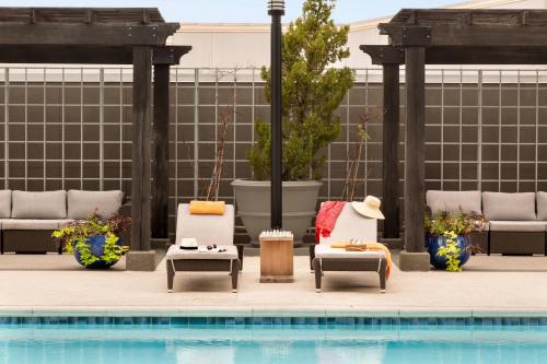 a group of chairs sitting next to a swimming pool at Twelve Midtown, Autograph Collection in Atlanta