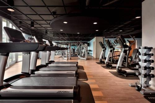 a gym with a row of treadmills at Twelve Midtown, Autograph Collection in Atlanta