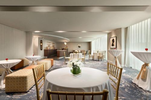 a waiting room with a table with flowers on it at Twelve Midtown, Autograph Collection in Atlanta