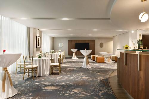 a banquet hall with tables and chairs and a stage at Twelve Midtown, Autograph Collection in Atlanta