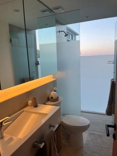 a bathroom with a toilet and a sink and a mirror at Beautiful Oceanview Apartment in Zantamar in Cruz de Huanacaxtle