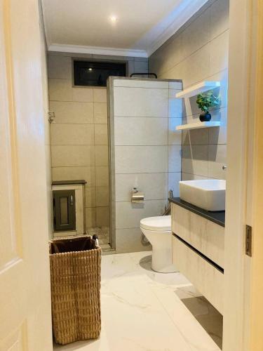 a bathroom with a toilet and a sink at Oceana Residence 2 in Mont Choisy