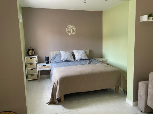 a bedroom with a bed and a desk in it at Demeure de Charme de la Gravière in Mably