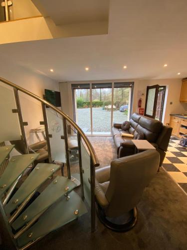 a living room with a couch and a stair case at Lovely 2 bed house in Hawkshead in Hawkshead